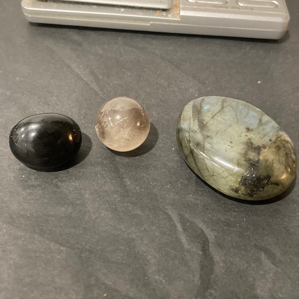 3 polished stones; 1 black onyx, 1 labradorite marble, 1 labradorite palm stone